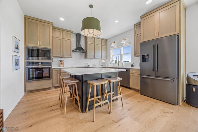 10128 Concord Dr, Horace, ND 58047 - kitchen featuring appliances with stainless steel finishes, wall chimney exhaust hood, light wood-style floors, light countertops, and recessed lighting