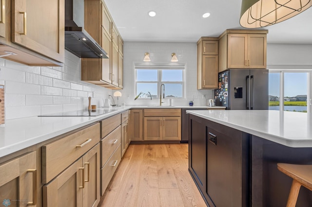 10128 Concord Dr, Horace, ND 58047 - kitchen with fridge with ice dispenser, wall chimney exhaust hood, light wood-style floors, recessed lighting, and light countertops