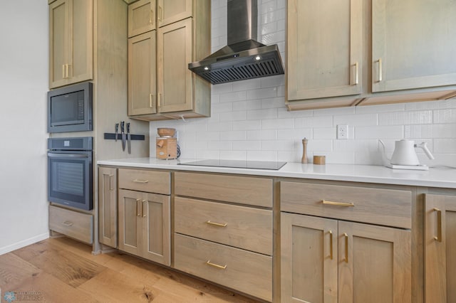 10128 Concord Dr, Horace, ND 58047 - kitchen featuring wall chimney exhaust hood, black appliances, light wood-type flooring, and backsplash