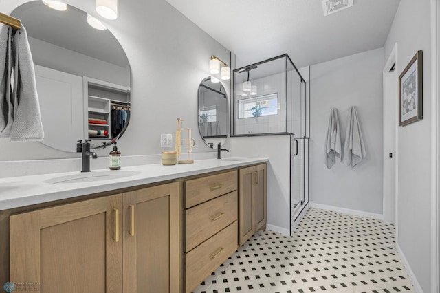 10128 Concord Dr, Horace, ND 58047 - bathroom with double vanity, a shower stall, tile patterned floors, and a spacious closet