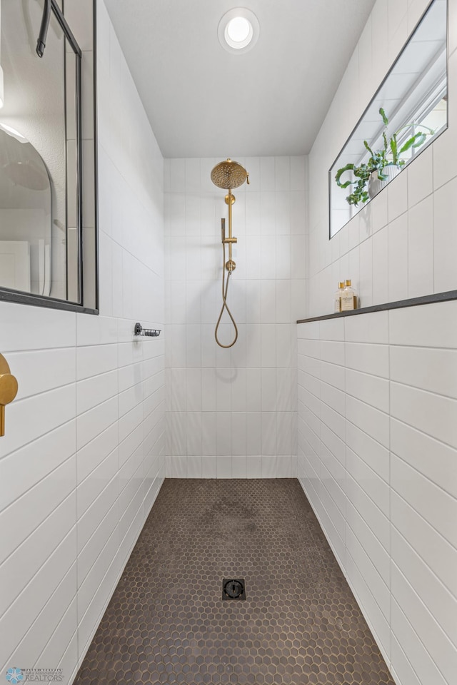 10128 Concord Dr, Horace, ND 58047 - bathroom with a tile shower, tile walls, and tile patterned flooring