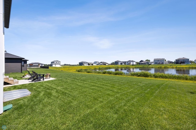 10128 Concord Dr, Horace, ND 58047 - view of grassy yard featuring a water view, a residential view, and a patio