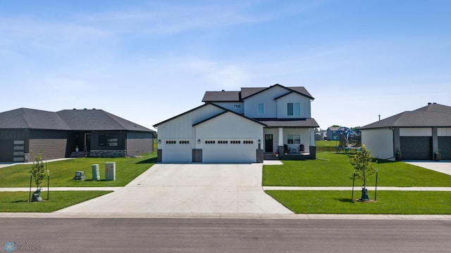 10128 Concord Dr, Horace, ND 58047 - view of front facade with a trampoline, a front yard, driveway, and a garage