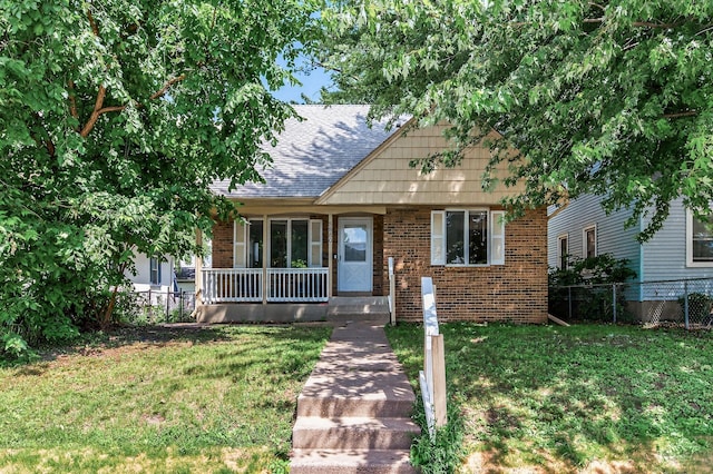 3850 Bryant Ave N, Minneapolis, MN 55412 - view of front of home with brick siding, covered porch, and roof with shingles
