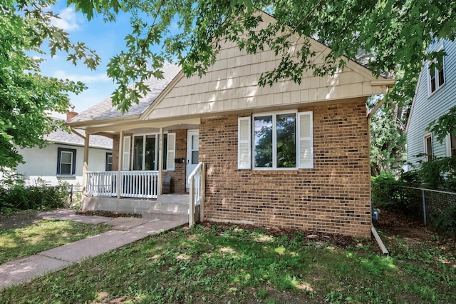 3850 Bryant Ave N, Minneapolis, MN 55412 - bungalow-style house with brick siding and a porch