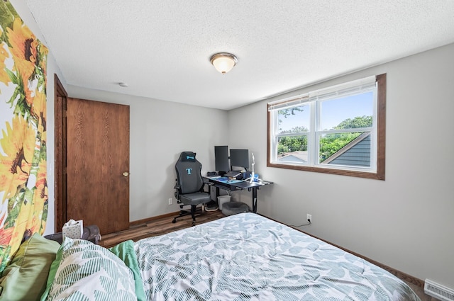 3850 Bryant Ave N, Minneapolis, MN 55412 - bedroom featuring a textured ceiling and wood finished floors