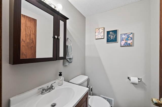 3850 Bryant Ave N, Minneapolis, MN 55412 - half bathroom featuring vanity and a textured ceiling