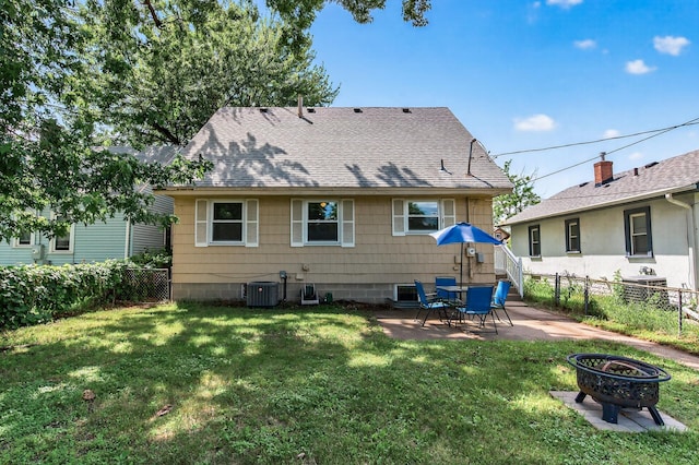 3850 Bryant Ave N, Minneapolis, MN 55412 - back of house with a fenced backyard, a patio area, an outdoor fire pit, and roof with shingles