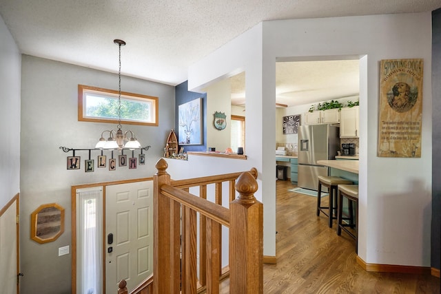 19161 Zane St NW, Elk River, MN 55330 - foyer entrance with a chandelier and light wood finished floors
