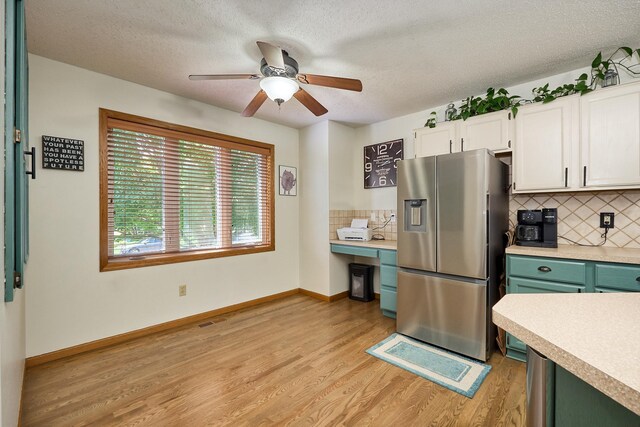 19161 Zane St NW, Elk River, MN 55330 - kitchen featuring stainless steel refrigerator with ice dispenser, light countertops, light wood-style flooring, white cabinetry, and a textured ceiling