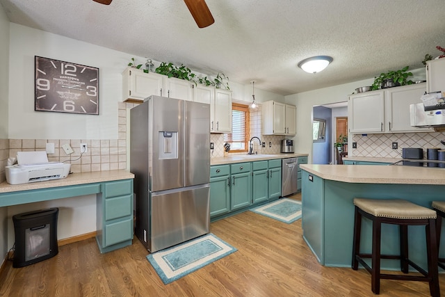 19161 Zane St NW, Elk River, MN 55330 - kitchen with appliances with stainless steel finishes, tasteful backsplash, light countertops, and a textured ceiling