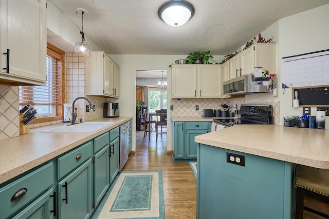 19161 Zane St NW, Elk River, MN 55330 - kitchen featuring appliances with stainless steel finishes, a textured ceiling, decorative backsplash, light countertops, and light wood-style flooring