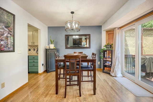 19161 Zane St NW, Elk River, MN 55330 - dining room with light wood-style floors and a chandelier