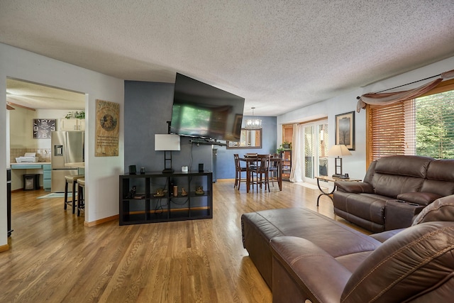 19161 Zane St NW, Elk River, MN 55330 - living area with a chandelier, a textured ceiling, and wood finished floors