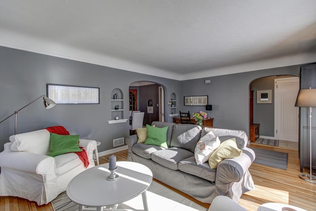 1331 2nd St NW, Rochester, MN 55901 - living area featuring arched walkways, wood finished floors, and built in shelves