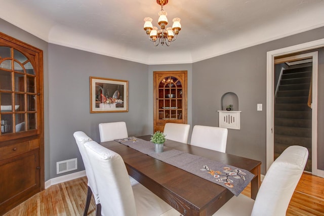1331 2nd St NW, Rochester, MN 55901 - dining room featuring a chandelier, light wood-style flooring, and stairs