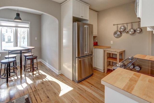 1331 2nd St NW, Rochester, MN 55901 - kitchen featuring high end refrigerator, light wood-style floors, arched walkways, and range with electric cooktop