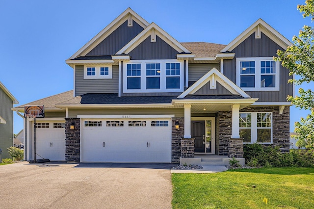 11887 73rd St NE, Otsego, MN 55301 - craftsman-style home featuring stone siding, a front lawn, concrete driveway, board and batten siding, and roof with shingles