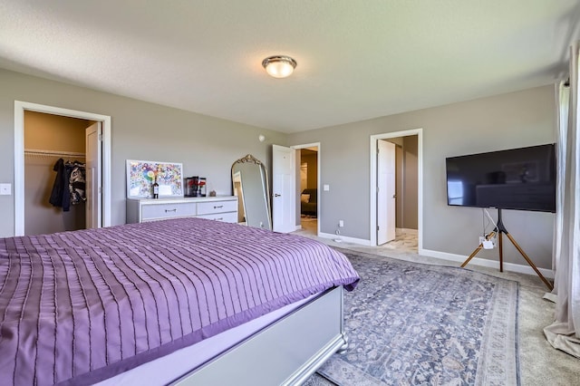 11887 73rd St NE, Otsego, MN 55301 - bedroom featuring light colored carpet, a walk in closet, and a closet