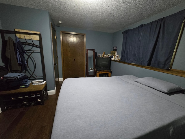 2108 74th Ave N, Brooklyn Park, MN 55444 - bedroom featuring dark wood-type flooring and a textured ceiling
