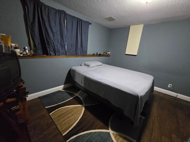 2108 74th Ave N, Brooklyn Park, MN 55444 - bedroom with wood finished floors and a textured ceiling