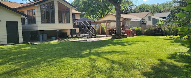 2108 74th Ave N, Brooklyn Park, MN 55444 - view of yard with a patio area, a gazebo, stairs, and a fire pit