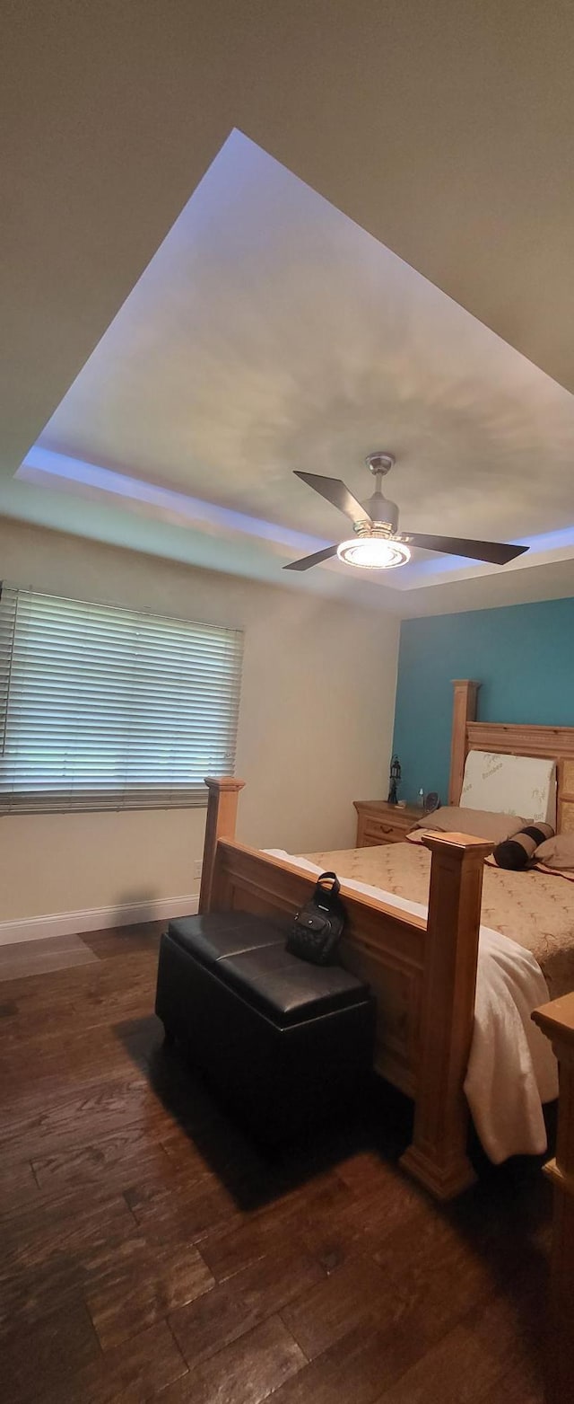 2108 74th Ave N, Brooklyn Park, MN 55444 - bedroom featuring dark wood-type flooring, a ceiling fan, and a wood stove