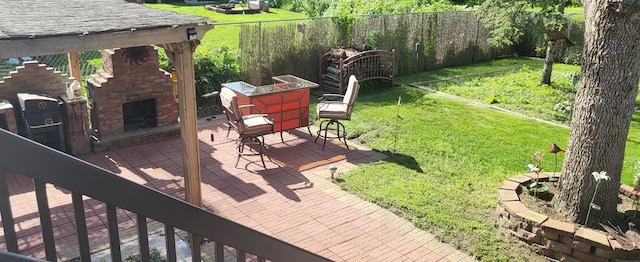 2108 74th Ave N, Brooklyn Park, MN 55444 - view of yard with an outdoor stone fireplace and a patio