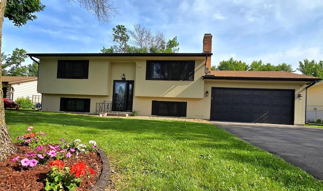2108 74th Ave N, Brooklyn Park, MN 55444 - view of front of house with stucco siding, a chimney, asphalt driveway, and an attached garage