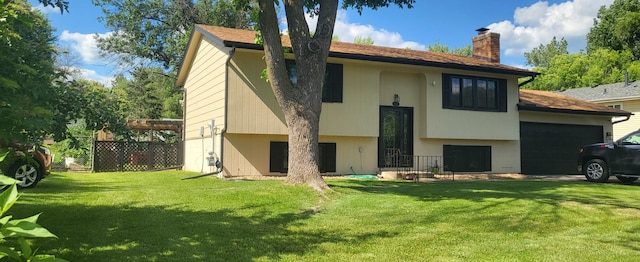 2108 74th Ave N, Brooklyn Park, MN 55444 - rear view of property with a chimney and an attached garage