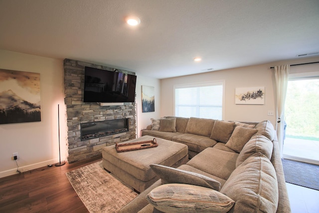 1267 Naser Way, New Richmond, WI 54017 - living area with healthy amount of natural light, dark wood-type flooring, a stone fireplace, and recessed lighting