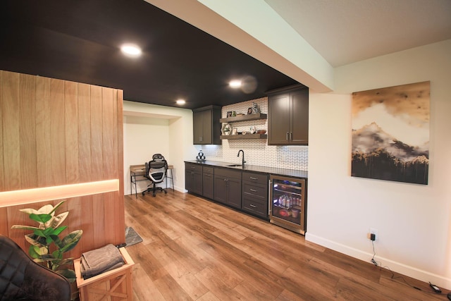 1267 Naser Way, New Richmond, WI 54017 - indoor wet bar featuring wine cooler, tasteful backsplash, light wood-style flooring, and recessed lighting