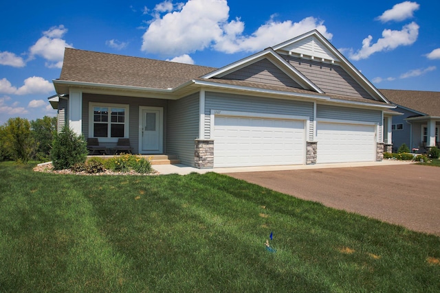 1267 Naser Way, New Richmond, WI 54017 - craftsman house featuring an attached garage, a front lawn, asphalt driveway, and stone siding