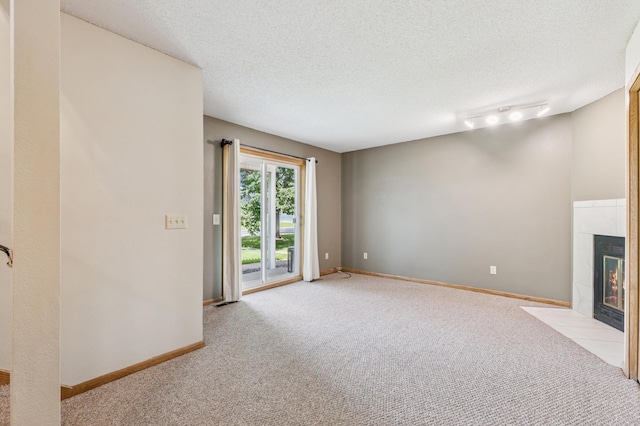 510 78th Ave NE, Spring Lake Park, MN 55432 - unfurnished living room featuring light colored carpet, a tile fireplace, and a textured ceiling