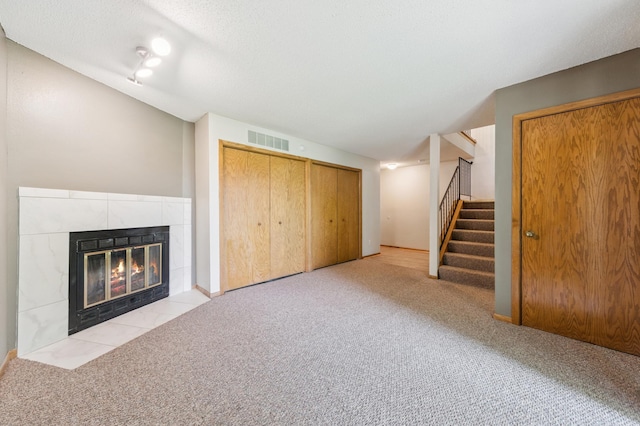 510 78th Ave NE, Spring Lake Park, MN 55432 - unfurnished living room with a tile fireplace, stairs, and carpet