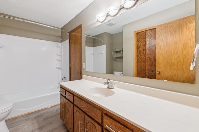 510 78th Ave NE, Spring Lake Park, MN 55432 - bathroom with vanity, wood finished floors, and shower / tub combination