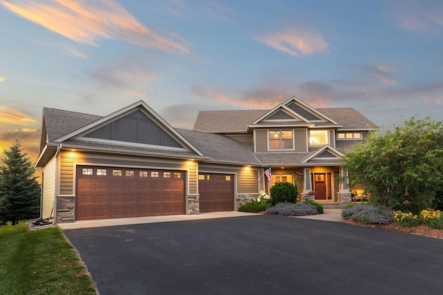 1899 White Oak Dr, Chaska, MN 55318 - craftsman-style home with stone siding, a garage, asphalt driveway, a porch, and a shingled roof