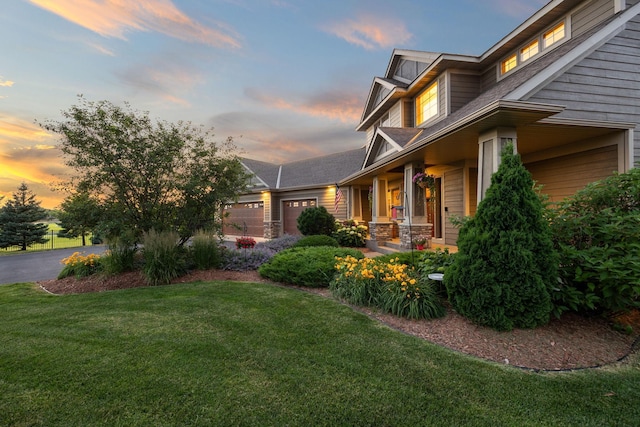 1899 White Oak Dr, Chaska, MN 55318 - view of side of home featuring a lawn, an attached garage, and covered porch