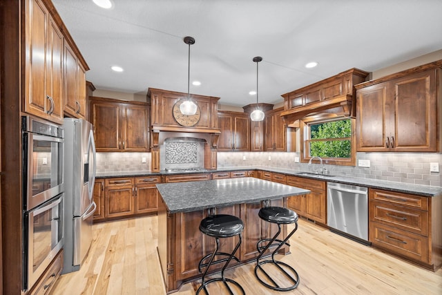 1899 White Oak Dr, Chaska, MN 55318 - kitchen with stainless steel appliances, light wood finished floors, a kitchen island, backsplash, and recessed lighting