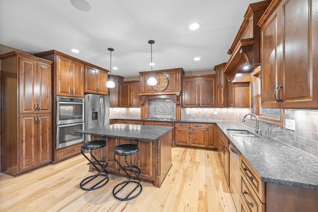 1899 White Oak Dr, Chaska, MN 55318 - kitchen featuring stainless steel appliances, a kitchen island, light wood-type flooring, a kitchen breakfast bar, and recessed lighting