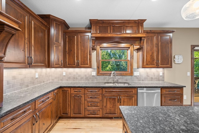 1899 White Oak Dr, Chaska, MN 55318 - kitchen featuring stainless steel dishwasher, light wood-style flooring, dark stone counters, and tasteful backsplash