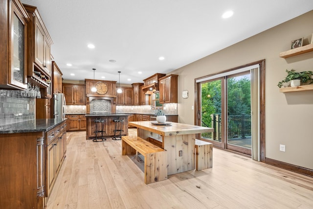 1899 White Oak Dr, Chaska, MN 55318 - kitchen featuring open shelves, decorative backsplash, light wood-type flooring, a center island, and recessed lighting