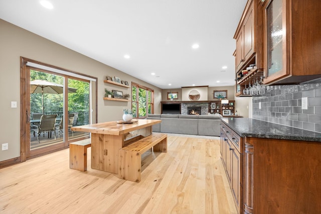 1899 White Oak Dr, Chaska, MN 55318 - kitchen featuring light wood-style floors, decorative backsplash, a lit fireplace, recessed lighting, and open shelves