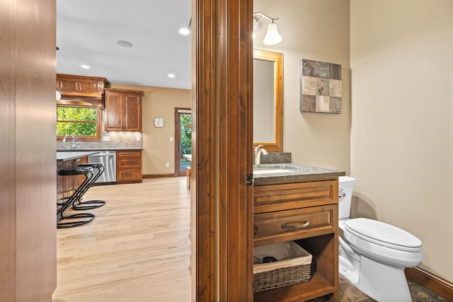 1899 White Oak Dr, Chaska, MN 55318 - half bath featuring wood finished floors, vanity, tasteful backsplash, recessed lighting, and ornate columns