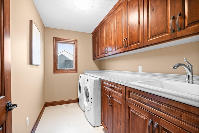 1899 White Oak Dr, Chaska, MN 55318 - washroom with cabinet space, washer and dryer, light flooring, and a textured ceiling