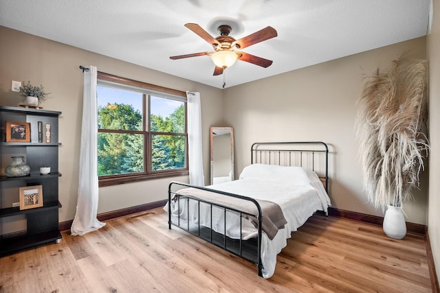1899 White Oak Dr, Chaska, MN 55318 - bedroom featuring light wood-type flooring and a ceiling fan