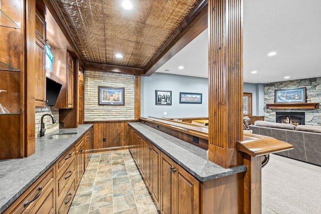 1899 White Oak Dr, Chaska, MN 55318 - bar area with a fireplace, wood walls, recessed lighting, and wainscoting
