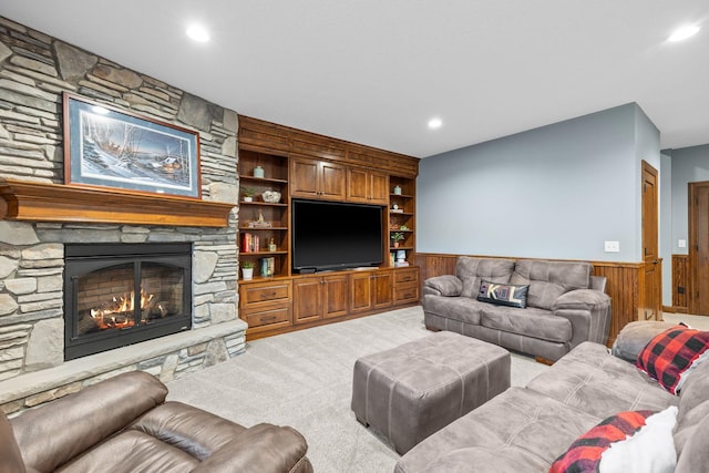 1899 White Oak Dr, Chaska, MN 55318 - carpeted living room featuring wainscoting, wooden walls, a stone fireplace, recessed lighting, and built in shelves