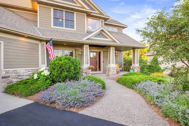 1899 White Oak Dr, Chaska, MN 55318 - entrance to property featuring roof with shingles, covered porch, and stone siding