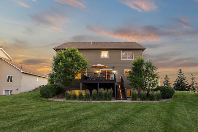 1899 White Oak Dr, Chaska, MN 55318 - back of property at dusk featuring stairway, a deck, and a lawn